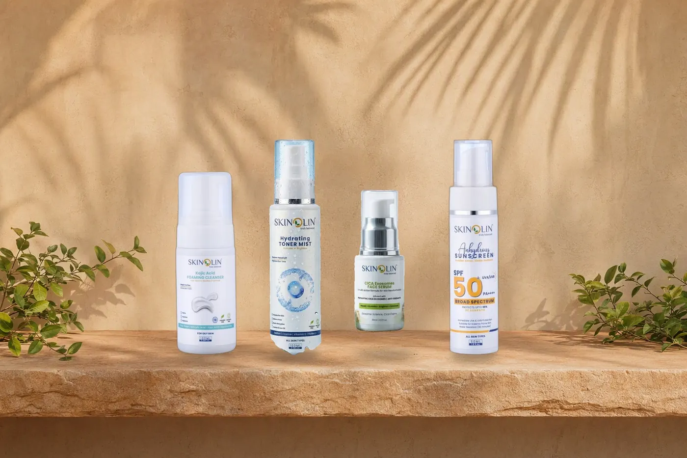 Skinolin cleanser, toner, serum and sunscreen on a sandstone shelf